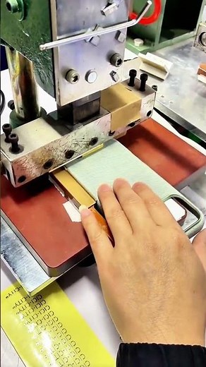 Embossing press stamps book spine—CICICTY foil aligns under firm hand