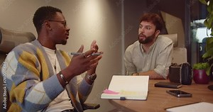 Diverse colleagues collaborate in a co-working space. Entrepreneurs, executives, and employees work together on a new project. Successful team focuses on tasks in a dynamic workplace.