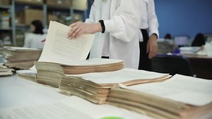 Office Workers Sorting printed Documents