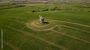 Landmark Chesterton historic windmill distant aerial view overflying English rural countryside farmland to Birdseye