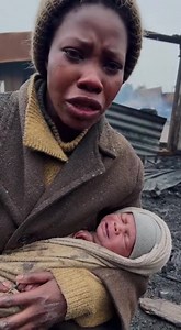 This is a close selfie video of an African mother sitting on the cold ground in front of her destroy | Tusiime orphanage care center