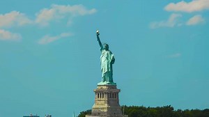Awesome video timelapse or time lapse animation of the Statue of Liberty falling together in its place and creating dust while boat masts and ships are moving in timelapse mode in the foreground. | Premium Stock Video Footage