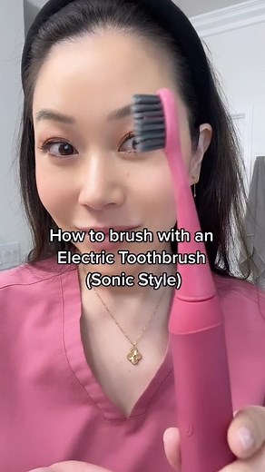 Dr. Joyce Kahng | Cosmetic Dentist OC Veneers on Instagram: "Episode 3 | How to brush your teeth with an electric toothbrush that utilizes sonic vibrations. Ie. Sonicare, Burst. Here I am using a Burst toothbrush in their newest color Berry. 🚫The biggest mistake I see is people brushing the same way they would with a manual toothbrush. Since the electric toothbrush is doing the work for you, you just want to slide and glide the toothbrush to different areas. If you are scrubbing with an electri