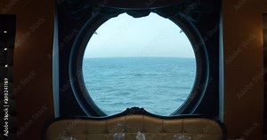 A huge round window on a cruise ship. incredible ocean view.