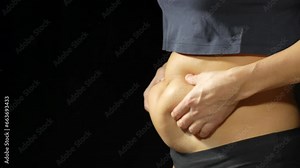 Obesity woman touching her belly.