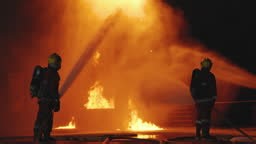 Firefighters' nighttime fire suppression training by simulating fire...