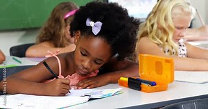 School kids doing homework in classroom at school 4k