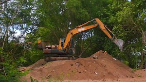 Extracting and loading gravel excavated.