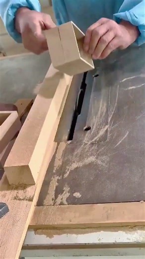 making precise vertical cuts on small wooden block using industrial table saw for woodworking task