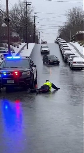 Officer Slips on Black Ice as Cars Slide Down Hill 🚓