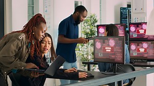 Diverse group of engineers having computer hacked and system crash on...