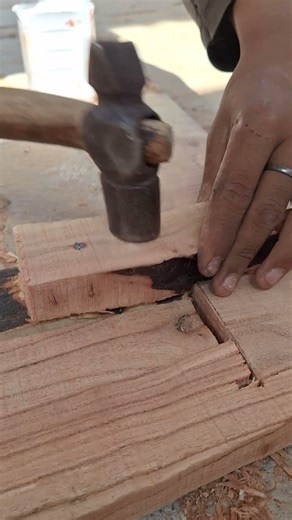 The correct way to hammer a nail into wood.