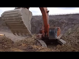 Hitachi Zaxis 650 LC excavator loading rock into dumpers