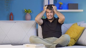 Man slapping himself with a nervous breakdown.