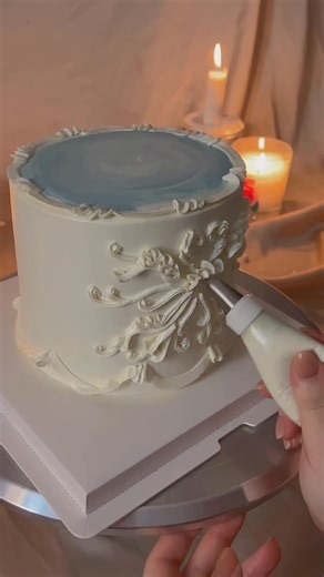 studiosweetly | nyc cakes on Instagram: "To achieve a fluid ombre, I like to apply a small dot of colored icing on top of white on iced cake as in video. It allows me to mix the color while preserving a sharp base. Small demo of freestyle scroll piping. #cakedecorating"