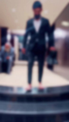 Man in Formal Suit Descends Grand Staircase Barefoot