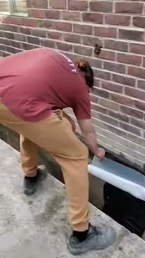 Applying tar aka roofing cement on exterior basement wall