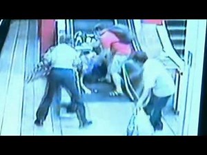 Woman rolls down escalator in motorised wheelchair