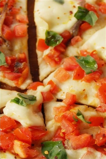 White pizza with fresh tomatoes, anchovies, and mozzarella