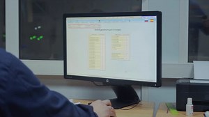 Person working on a computer in a factory | Premium Stock Video Footage