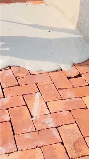 the process of leveling white cement on a brick floor #construction #cement #brick #shorts