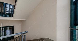 loop rotation and panoramic view on emergency stairs in empty modern hall with panoramic windows overlooking the city.