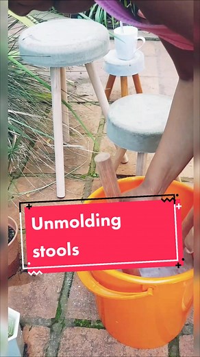 Me, unmolding the concrete stools. I mixed sand and cement, poured the mix in buckets as my molds, stick the wooden legs in the wet concrete mix and unmolded 48 hours later. Normally I unmold 24 hours later but the concrete mix was on the watery side, so it takes longer to dry. #concretedecor #concretelife #concrete #concretefurniture #homedecorideas #interiordecor #behindthescenes #behindscenes #handmadewithlove #ugandanstiktok