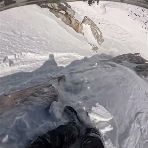 Snowmobile mishap on mountain slope in Laramie, Wyoming, USA