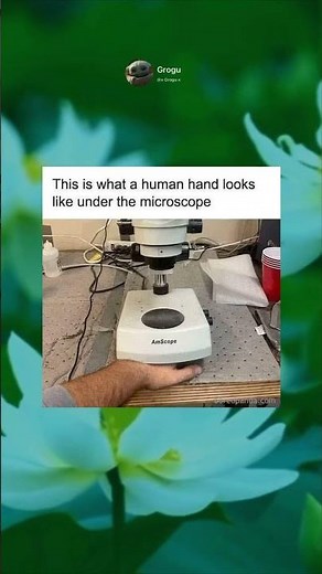 Human hand under microscope