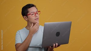 Young adult experiencing variety of emotions while using laptop