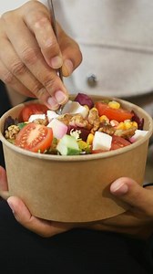 Download Enjoying a fresh salad with colorful ingredients and toppings for free