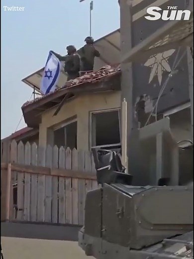Soldiers raise Israeli flag near Gaza-Israel border amid ground operations
