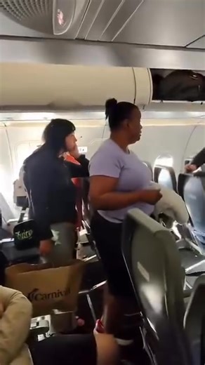 A Frontier Airlines passenger refuses to let anyone behind her off the plane, demanding her daughter several rows back be allowed to exit first. The tense standoff halts deplaning as a flight attendant steps in, pleading with the woman to clear the aisle. Fellow passengers can be heard growing frustrated as tempers boil over in the packed cabin. #FrontierAirlines #AirlineDrama #CabinCrew #PassengerMeltdown #TravelChaos #CrewLife #UnitedByWings | Tim Fazenbaker
