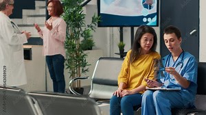 Medical assistant showing x ray exam results to asian patient, explaining disease diagnosis and healthcare treatment. Analyzing radiography scan at orthopedic consultation in health center.