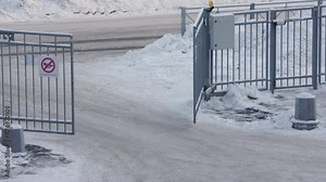 Modern design motorized automatic driveway gate, fence gate of the courtyard of a residential building in winter. High quality 4k footage