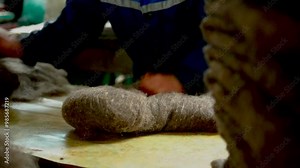 felt boots - winter footwear. products of a fulling felt factory. warm boots in stock. preparations for fulling wool products. product molding. stock wool for shoes