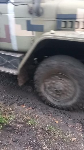 Military Truck Navigating Muddy Terrain Close-Up