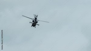 close-up of British army Boeing Apache Attack helicopter gunship AH64E AH-64E performing pilot military flight training manoeuvres, Wiltshire UK