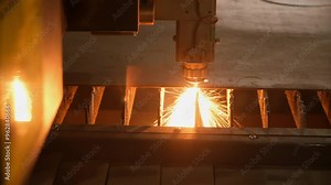 Laser cutting of metal sheet edge on automated plasma cutter machine on plant factory. Industrial manufacturing metal parts details products. Metal heavy industry production, metalwork process.