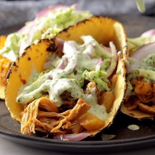 These Instant Pot Hawaiian Chicken Tacos are out of this WORLD. 😮 Juicy pineapple and spiced chicken crisped under the broiler, tucked into tortillas, and rolled up with creamy jalapeño ranch slaw! 🌮 https://pyum.co/2VS8NWD | Pinch of Yum