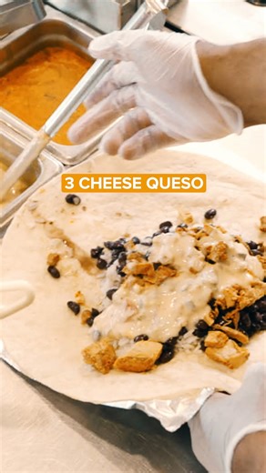 I could watch this Chicken Queso burrito build all day. 😍 | QDOBA