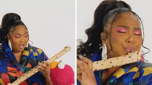Elmo offers Lizzo a literal cookie flute to play