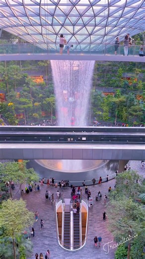 The HSBC Rain Vortex, the largest and tallest indoor waterfall in the world, located inside Jewel Changi Airport in Singapore. | Traveltasia