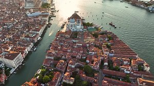 Venice from the sky, showcasing Basilica, Grand Canal, Punta della Dogana triangular shape architecture, in the heart of Venetian Lagoon, Italy
