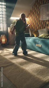 Girl turning on recording on camera, dancing and doing funny moves, looking at camera, introduction yourself, spending leisure time at home. Vertical shooting. Phone screen view. Vertical shot video