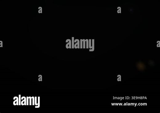 Glowing particles floating in darkness Stock Video Footage - Alamy