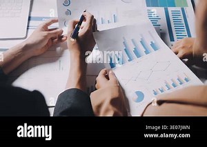 Two Businessman Calculating Bills Using Calculator At Workplace. Business team meeting and discussing project plan. Businessmen discussing together in meeting room