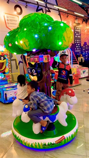 So fun riding a colorful carousel horse with cute green trees! 🎠🌳✨ #cutebaby #carousel