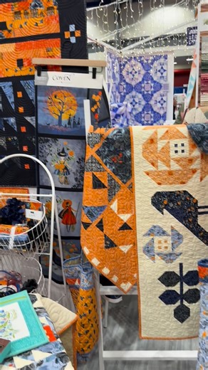 Robin Pickens Designer+Artist on Instagram: "Booth setup at Quilt Market. Coven lovelies, ready to show! #quiltmarket #robinpickensfabric #covenfabric #halloweenfabric #modafabrics #robinpickensquilts #halloweenquilts"