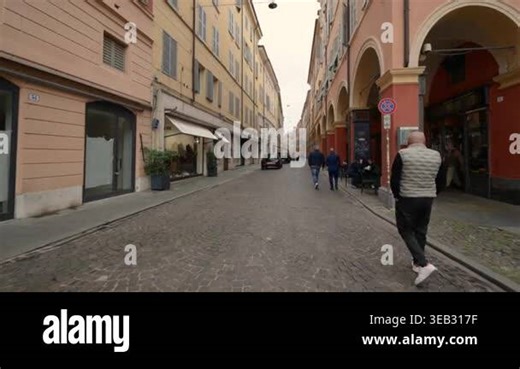 Modena, italy, april 12, 2026. A captivating point of view walking down a typical italian street in the historic center of modena, emilia romagna, surrounded by arcades Stock Video Footage - Alamy